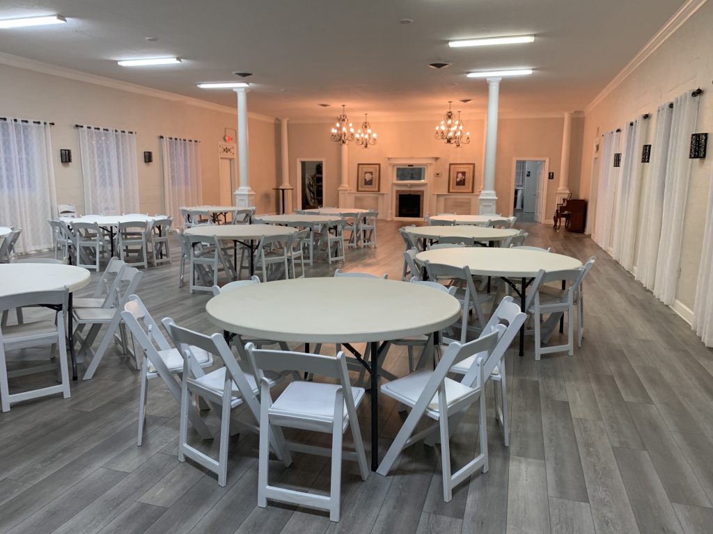Large banquet room set up with round tables and chairs.