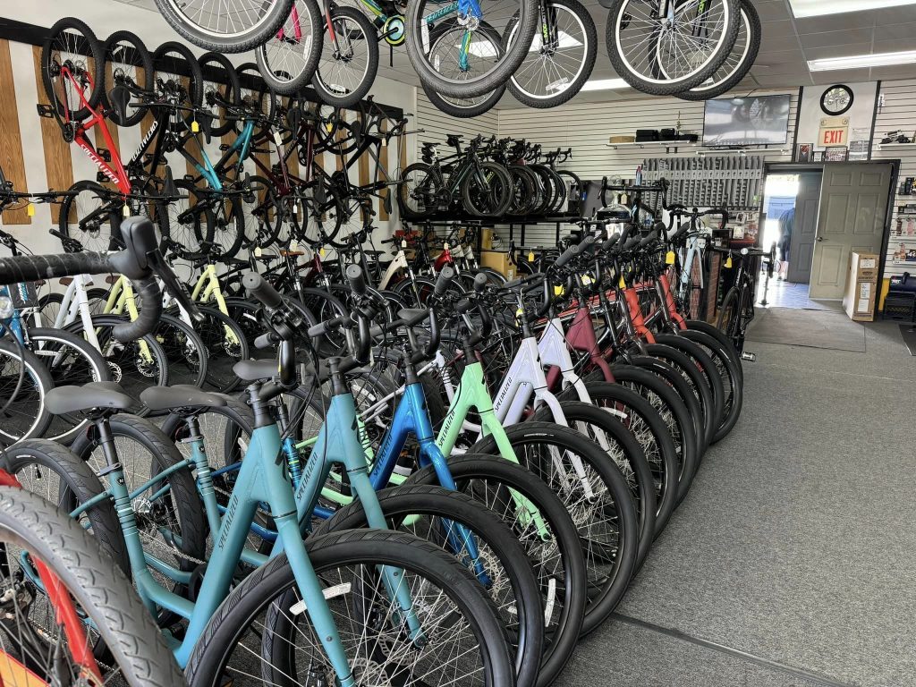 Bicycles lined up in a retail store all colors and sizes