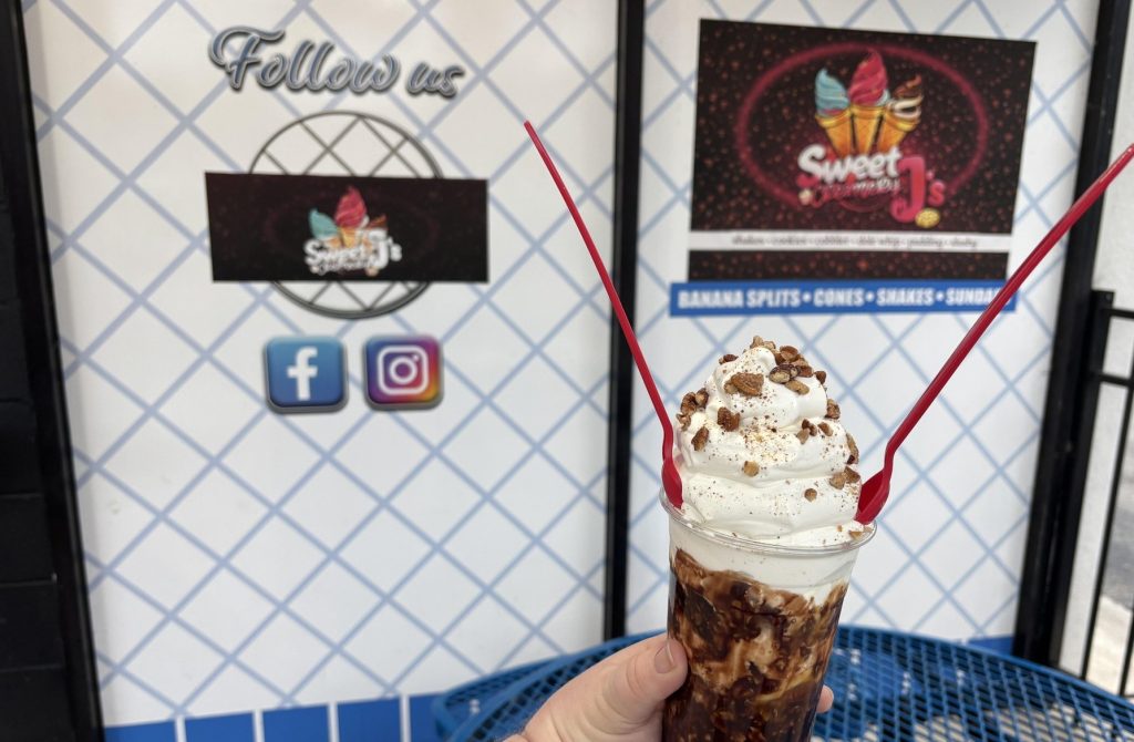 image of a turtle sundae in the front of the sweet j creamery storefront
