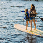 Two people on a paddle board in Clay County