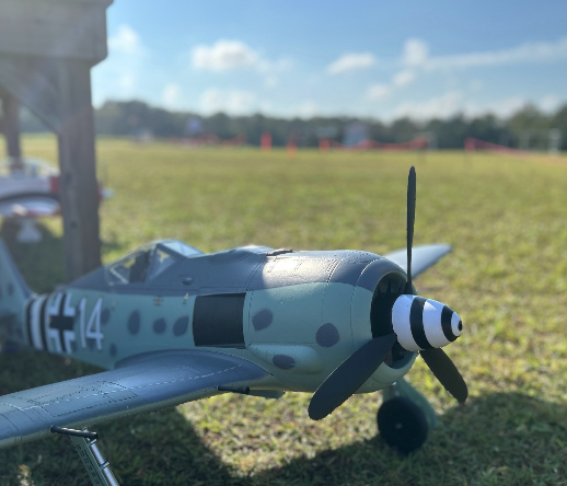 Toy plane in an open field.