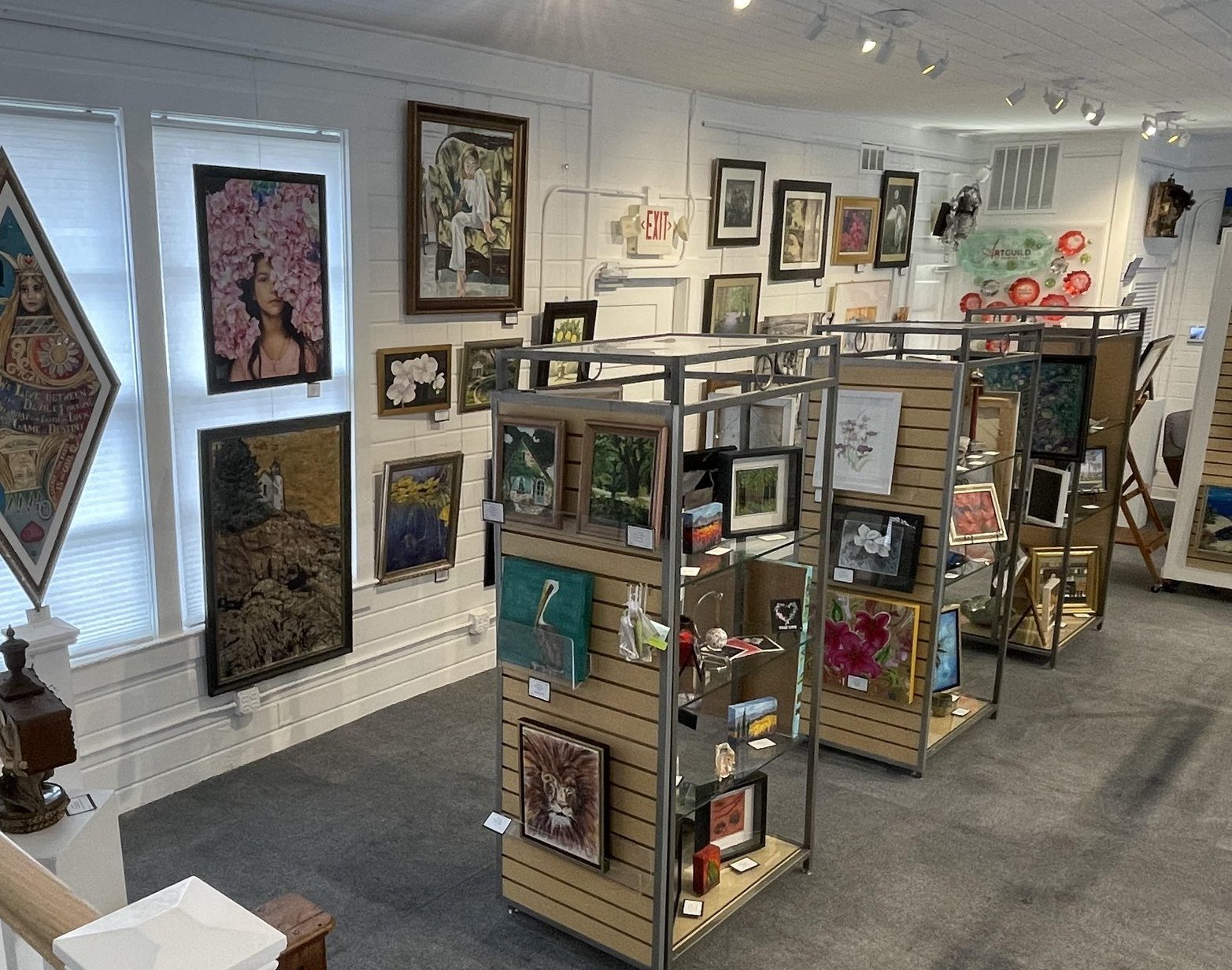 Interior image of the art guild gallery showcasing paintings and fine art on display kiosks